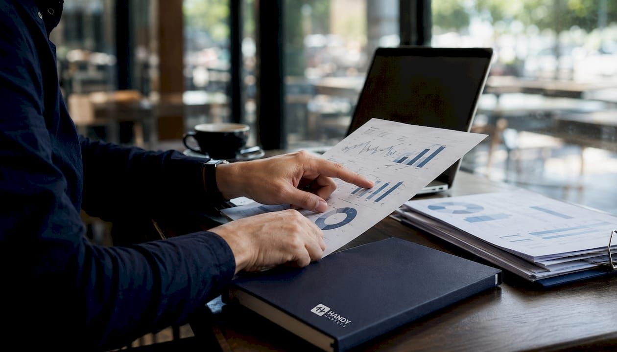 Hands reviewing financial metrics on report
