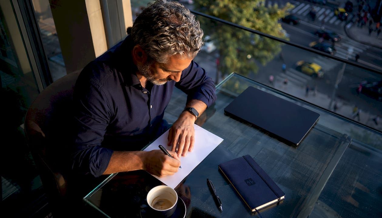 Man writing investment policy statement notes