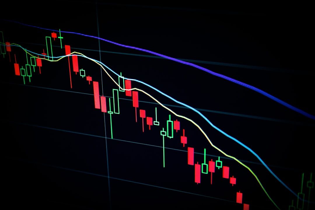 Trader at desk with multiple monitors engaged in arbitrage trading