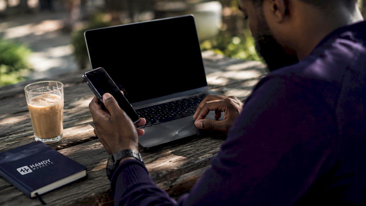 Trader comparing cryptocurrency prices on devices at café