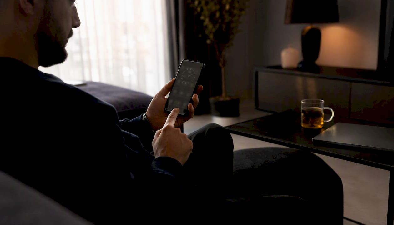 Trader hand checking timestamp on phone