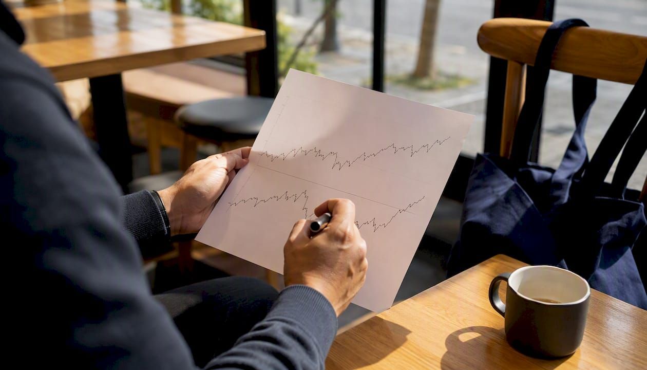 Trader marking breadth chart with pen